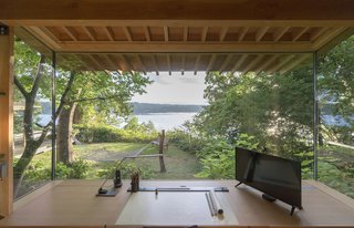The workstation and the cabinets are by Korben Mathis Woodworking; the desk lamp is from TaoTronics.