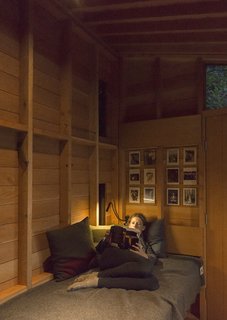 Opposite Jim’s workstation, the modest interior accommodates a single bunk outfitted with Woolrich linens and pillows designed by Jim's wife, Beth Wheeler. 
