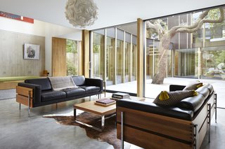 The sofas are designed by Robin Day for Habitat. The walnut frame nicely contrasts with the soft leather cushions. 