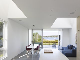 9 Marvelous Waterfront Homes - Photo 2 of 10 - The Quonochontaug House in coastal Rhode Island is located three hours from New York City and is built as a retreat for a family from Brooklyn. The design is organized around an open-plan ground floor punctuated by a series of double-height sky-lit spaces that progress from entry to bay view.