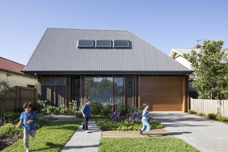 Porjazoski thought that reinterpreting a traditional pitched roof in a highly angled form would set the home apart from its neighbors. The roof is made from Colorbond Custom Orb in "Wallaby."