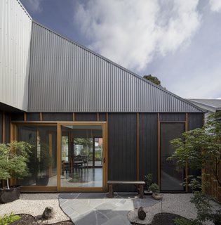 The owners, a couple in their 40s with a young child, wanted a home with easy access to the outdoors. "Large sliding doors establish a fluid connection with the outdoor spaces," Porjazoski says, which includes a courtyard and rear garden. 