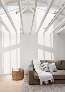 A custom Viesso sofa is accessorized with a West Elm throw and mudcloth pillows sourced from Etsy.