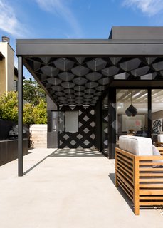 A steel-and-redwood fabrication makes up the diamond shape of the trellis. 