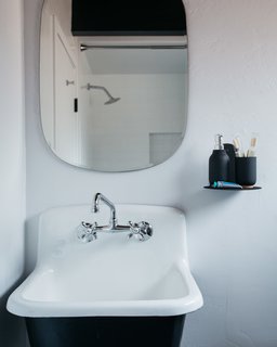 A 1970s A-Frame Cabin in Big Bear Is Brought Back to Life - Photo 12 of 12 - "We borrowed from a bohemian look for the bedrooms, and opted for a rustic look for the bathroom," Poulos says. A West Elm mirror above the sink adds to the charm. 