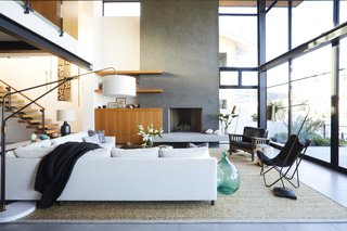 A cream-colored Mitchell Gold + Bob Williams sectional designates the living area in this open concept, as does a Kochi Pattern rug from the Taj Collection at Area Rug Factory. 