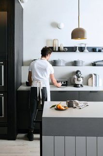 "The wood paneling that surrounds the island is identical to the paneling on the eighth floor test kitchen backsplash," Sherman says, but this time, it's in darker shades. 