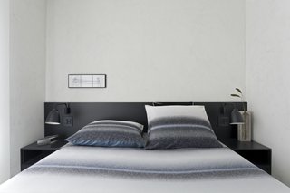The black lacquer finish used in the common area was repeated in the design of a headboard for the master bedroom. 