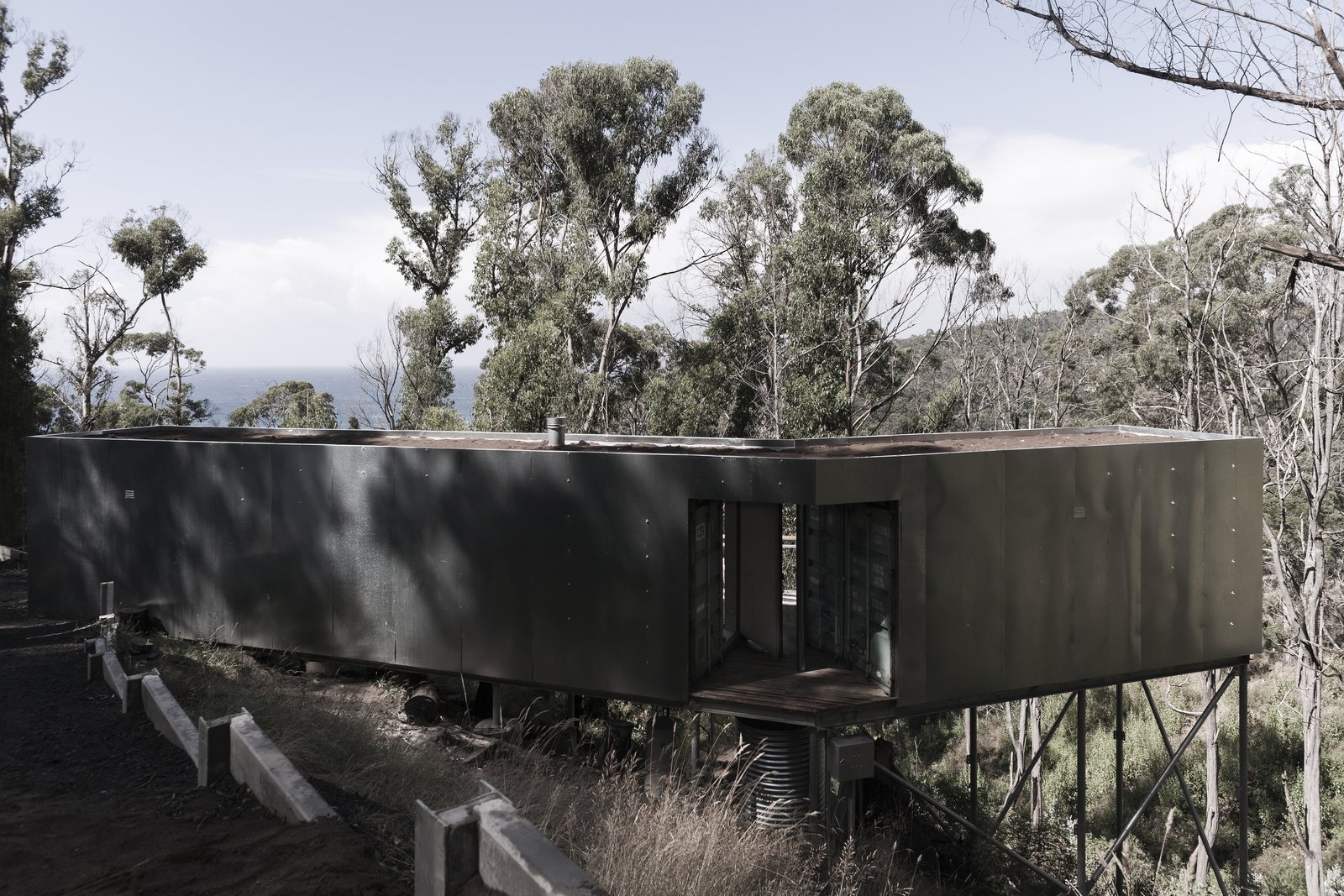 The two ends of the containers can be opened or closed at this pivot for more or less privacy. Native plants will grow on the roof and northside of the structure.