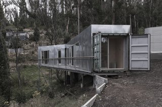 This Off-Grid Container Home in Australia Disappears in Nature - Photo 2 of 8 - One end of the home connects to the existing access path, which helped make construction to the site as minimal as possible. Edwards also positioned the property so that a studio space could be built below the home in the future. 