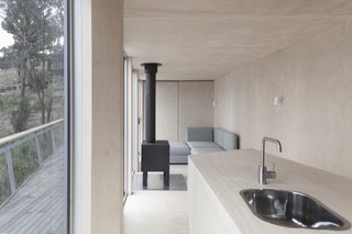 This Off-Grid Container Home in Australia Disappears in Nature - Photo 3 of 8 - Marine plywood is the dominant feature of the interior. 