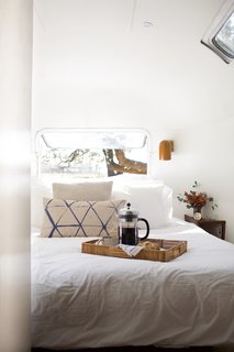 The owners originally wanted a king-size bed, but that was too large. Therefore, Oliver and Prasse made a custom one that was as big as the layout allowed. The pocket door to the room gives the owners privacy from guests and their dogs, when needed. 