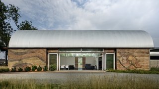 The two buildings are entirely made of renewable resources, which is best exemplified by its 30-inch-thick walls made of rammed earth. The first building serves as DiDomenico's residence, while the second is a 7,000-square-foot open space for her to create her artwork. 