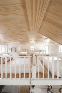 "Having the double loft really created a lot of sleeping space for our kids—we have two double beds and two single beds up there," Jorie says. "Unlike a lot of tiny homes, we do have our own separate bedroom that is in the front of the home."