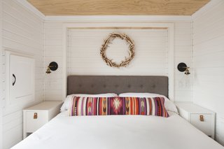 Jorie found these skinny end tables at IKEA, and chose a bed that could be lifted to hide extra bedding and supplies. She explains she wanted the interior of the home "to be light filled, airy, and as open as possible."