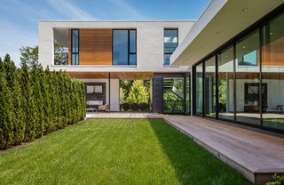 The home's L-shaped design conceals an outdoor pool and yard from the neighbors. 