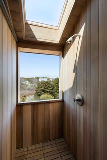 A second-story outdoor shower sits at the top of the stairs. California Faucets supplied the shower head and shower arm. Eco Arbor interlocking deck tiles were used on the floor. 