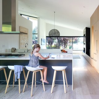 Hay stools are lined in the completely renovated kitchen, which is punctuated by an abundance of natural light and a large Moooi Random Light. 