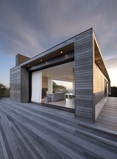 Masi used Lutron lighting indoors and out for a cohesive look—much like the continuation of mahogany throughout the property.