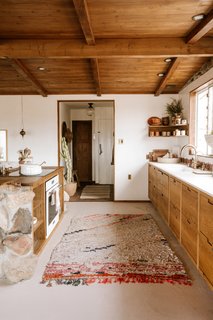 "We believe that the space should feel like it belongs in the environment and community that it’s a part of," Rich says. For this kitchen, that means sticking to natural materials—including the stone accent on the island and the cactus near the entryway. 