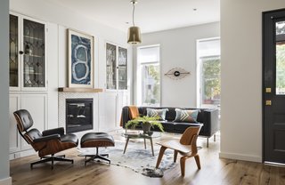 Barker salvaged the original glass windows in this living room, although the surrounding millwork had to be replaced. 