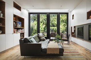 To save money, the team sourced IKEA cabinet bodies for the kitchen and den, and then built and assembled them on-site.