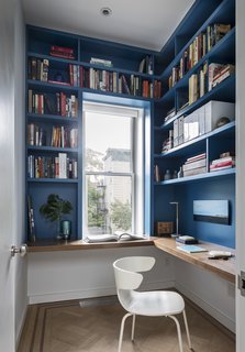 "I particularly love the blue paint on the custom millwork in the small office on the second floor," Barker says. She used paint to make an impact throughout the home without breaking the bank.