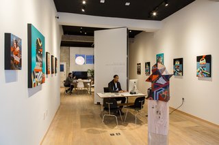 ELL's folding wall supports both a formal gallery space and private conference area. 