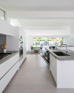 The panel ready dishwasher, with functional third rack, is tucked seamlessly into the kitchen island.