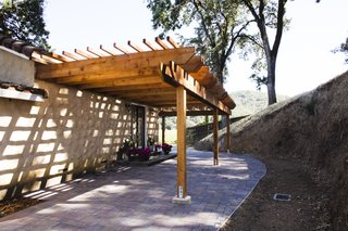 The second pergola shades the entryway to one guest casita, extending the private outdoor living space.