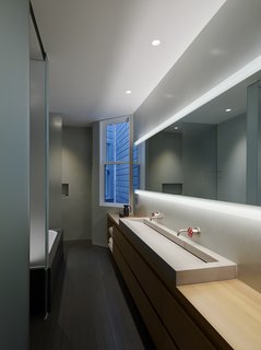 A Historic Victorian in San Francisco Is Meticulously Transformed Into a Modern Family Home - Photo 20 of 26 - The long and narrow master bathroom features Marmorino plaster walls, Fireclay tile, a custom concrete sink, and Pipe faucets from Boffi.