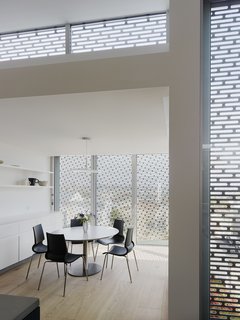 A Historic Victorian in San Francisco Is Meticulously Transformed Into a Modern Family Home - Photo 17 of 26 - Open shelving continues from the kitchen to the sun room, with a Big Break dining table from Cappellini and Gigi chairs from Knoll.