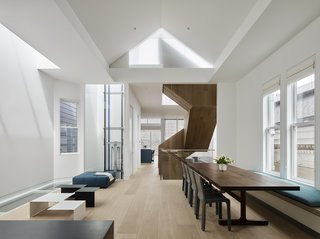 A Historic Victorian in San Francisco Is Meticulously Transformed Into a Modern Family Home - Photo 14 of 26 - The home’s elevator features a glass cab and exposed mechanical elements. The already high Victorian ceilings were extended vertically to the top of the attic’s pitch, where a skylight was added.