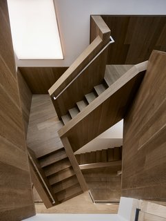 A Historic Victorian in San Francisco Is Meticulously Transformed Into a Modern Family Home - Photo 13 of 26 - The stair features custom installations by lighting designer Johanna Grawunder. When turned off, the panels appear as mirrors. When on, they reflect LED lights, giving the twisted stair forms an exaggerated "funhouse-like" effect.