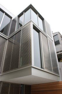 A Historic Victorian in San Francisco Is Meticulously Transformed Into a Modern Family Home - Photo 21 of 26 - The home’s dramatic rear facade is composed of perforated metal screens by Flynn & Enslow, which are attached to Fleetwood windows. The second-floor bump out is cantilevered with no structural post below.