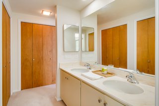 Original bathrooms and closet doors are charming remnants of the past and add to the unique character of the storied home.