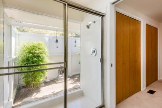 The indoor/outdoor shower is also original.