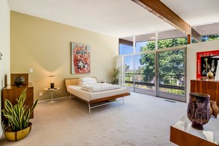Four bedrooms, all generously sized, receive abundant light from the floor-to-ceiling glazing.