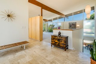 Original built-ins act as a visual divider in the living space.
