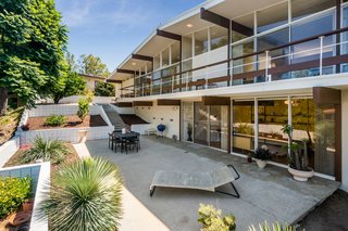 Drought-tolerant landscaping accents the backyard. The rear elevation features impressive spans of glass, original to the home.
