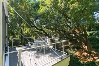 An Amazing Tree-Covered Glass House For Sale in the Berkeley Hills - Photo 11 of 20 - The deck is supported by a large beam that's bolted and tied to the main part of the house with steel cables.
