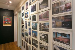 An Amazing Tree-Covered Glass House For Sale in the Berkeley Hills - Photo 12 of 20 - An architectural photo collection adorns an entry wall.