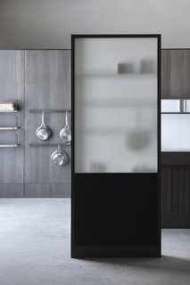 The wall offers elegant spatial screening, without dividing a space too harshly. The opaque white glass provides both privacy and transparency.