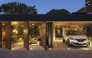 An Incredible Brazilian Home That Celebrates Art, Travel, and Nature - Photo 13 of 14 - Expansive doors on either side of the home’s living space can instantly offer privacy—or complete openness to the elements.