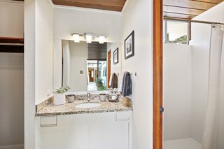 Simply updated, the adjoined master bathroom has a bright shower and spacious walk-in closet.