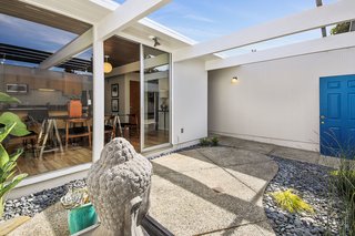 The tranquil entry atrium welcomes guests into the home.