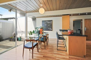 Natural wood-plank ceilings remain beautifully intact in the single-level, post-and-beam home.