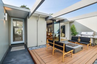 The entry atrium includes a cozy seating area with a gas fireplace.
