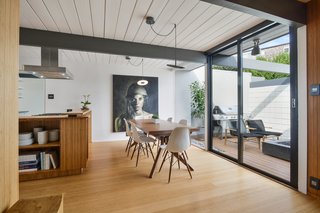 Giant sliding glass doors from Fleetwood connect the dining room to the atrium.