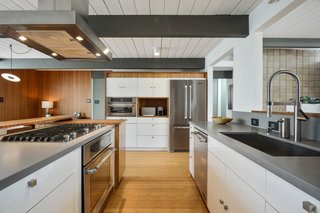 Original beams and painted wood ceiling planks are featured throughout the public spaces.